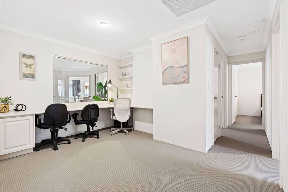 Enjoy this bright, dedicated area with desks and chairs, perfect for working remotely together.