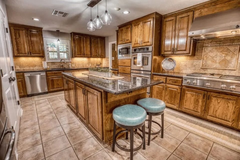 Gourmet eat-in kitchen with gas range and dual ovens. 