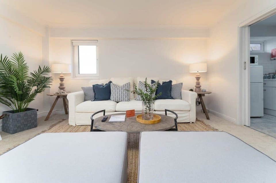 The living room is light and airy with a soothing chill time vibe