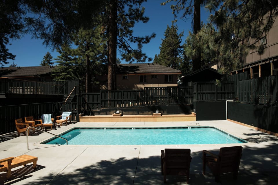 Dive into the sparkling pool and lounge under tall pines.