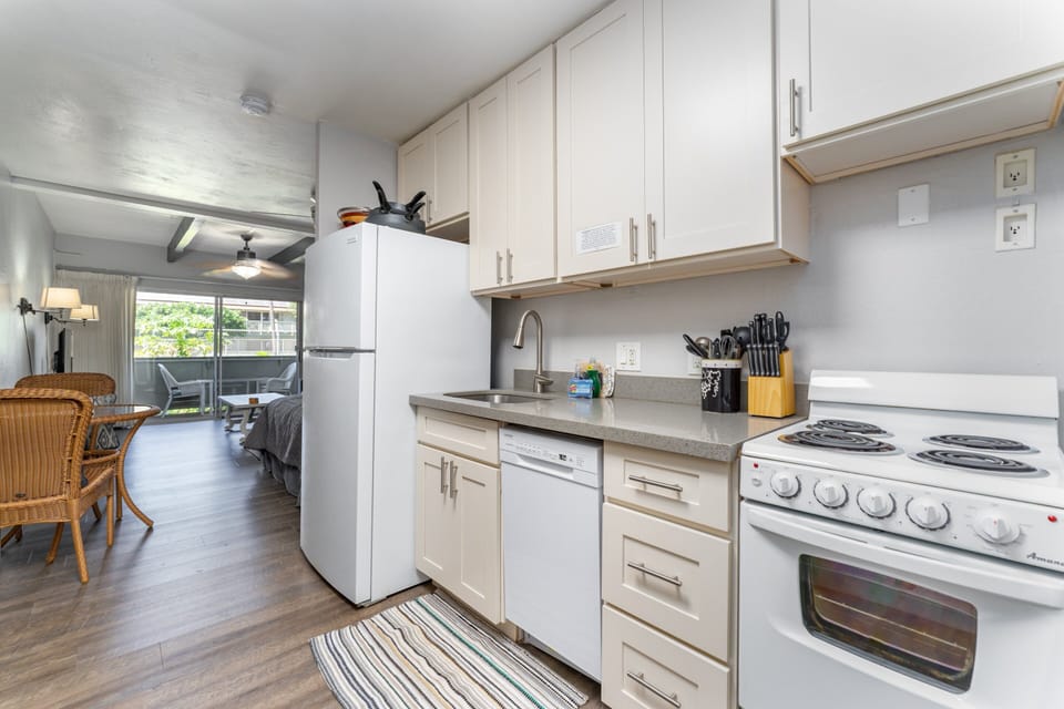 Kitchen has stove, oven, fridge, dishwasher, coffee maker, microwave