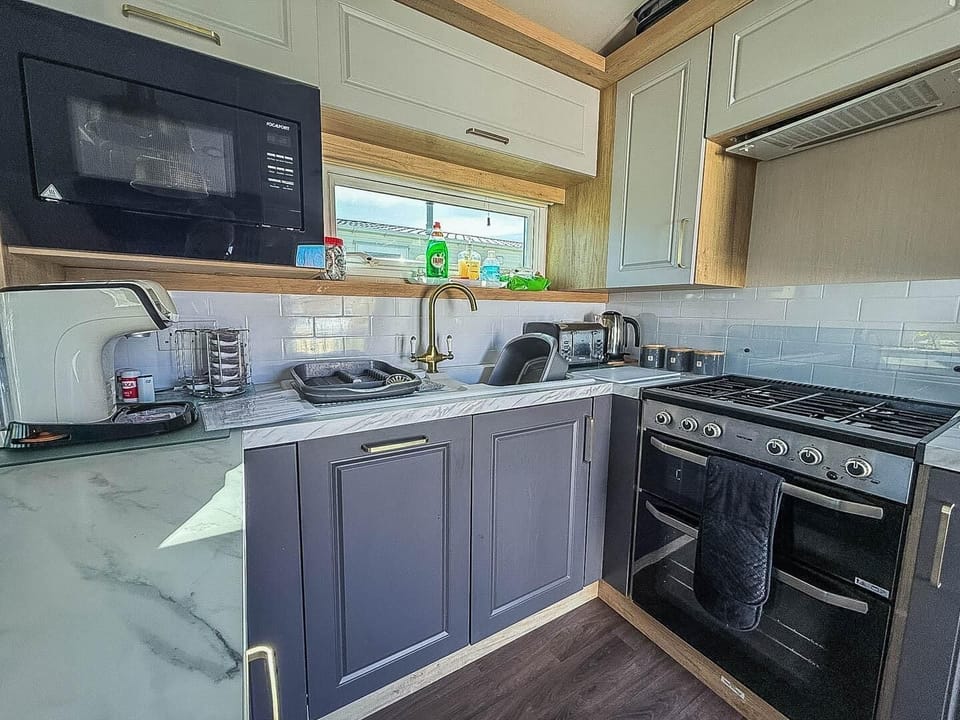 Cook up a storm in the kitchen area of a static caravan at Hopton Holiday Village Norfolk, after a day of fun on the Norfolk coast with your family on holiday.