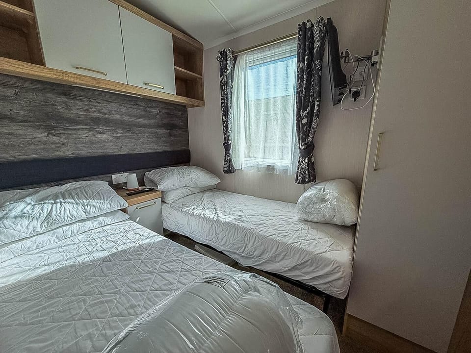 Spend your family holiday in the UK at Hopton Holiday Village, where the bedrooms in a static caravan provide a relaxing space after exploring the nearby Norfolk beaches.