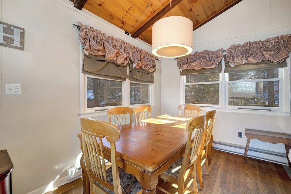 Share meals and memories at this cozy dining table, where warm lighting and natural textures create the perfect setting for everything from morning coffee to family dinners.