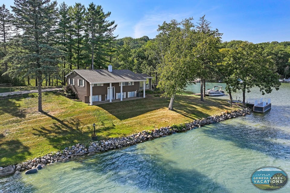 Outside of home, shoreline. Boat tie-up on landing to far right