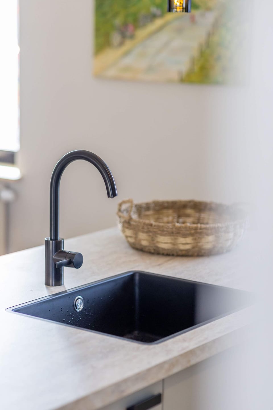 A detail worth noting - the matte black faucet and sink add a touch of elegance to the kitchen island.