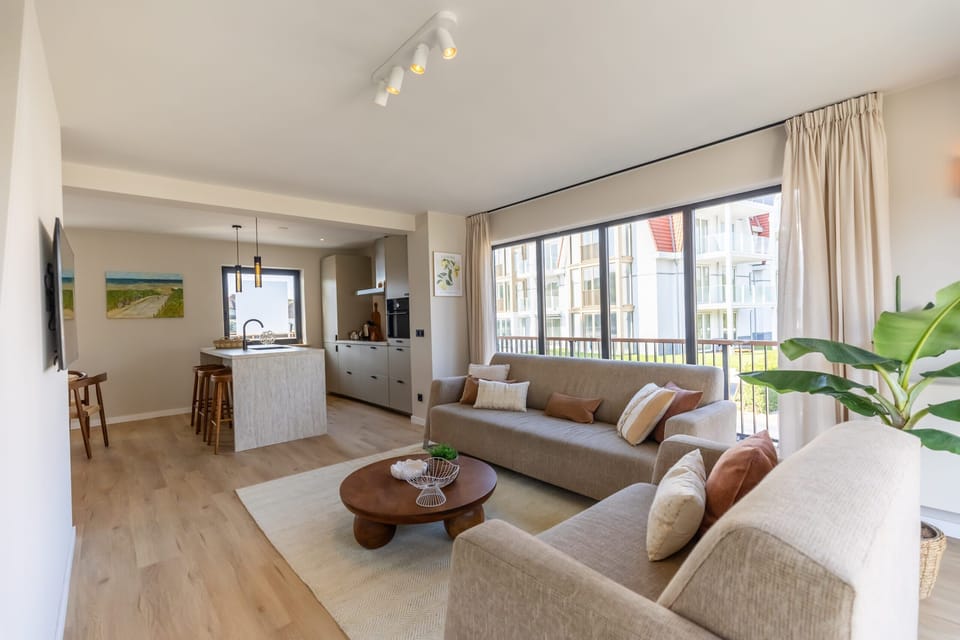 Enjoy quality time together in this beautifully designed open-plan space with natural wood flooring, modern art, and direct garden access.