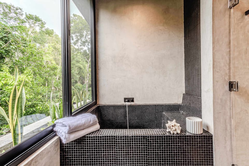 Bathroom 2 | Jacuzzi bathtub overlooking lush jungle scenery