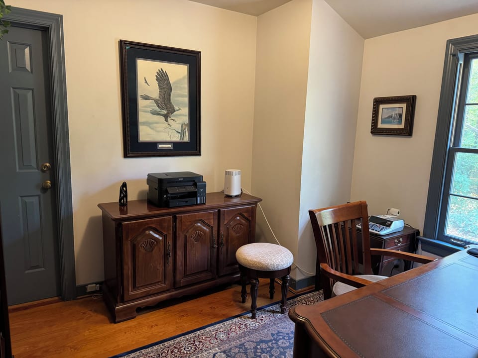 Separate office space with computer, monitor, printer and office supplies.