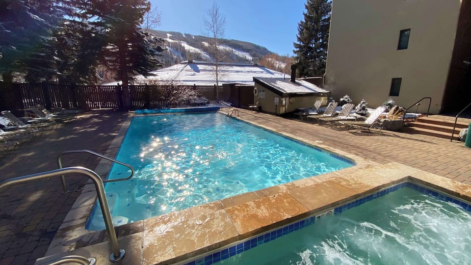 Outdoor pool and hot tub with views to Vail Mountain