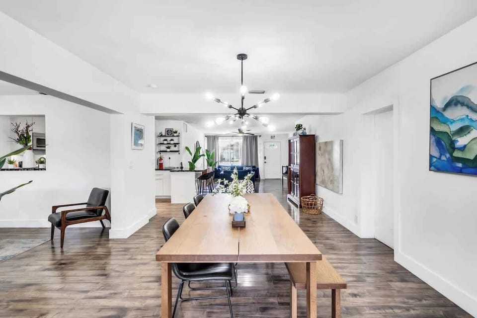 "Gather in style—this Airbnb features a sleek dining setup, modern art, and open-concept comfort."