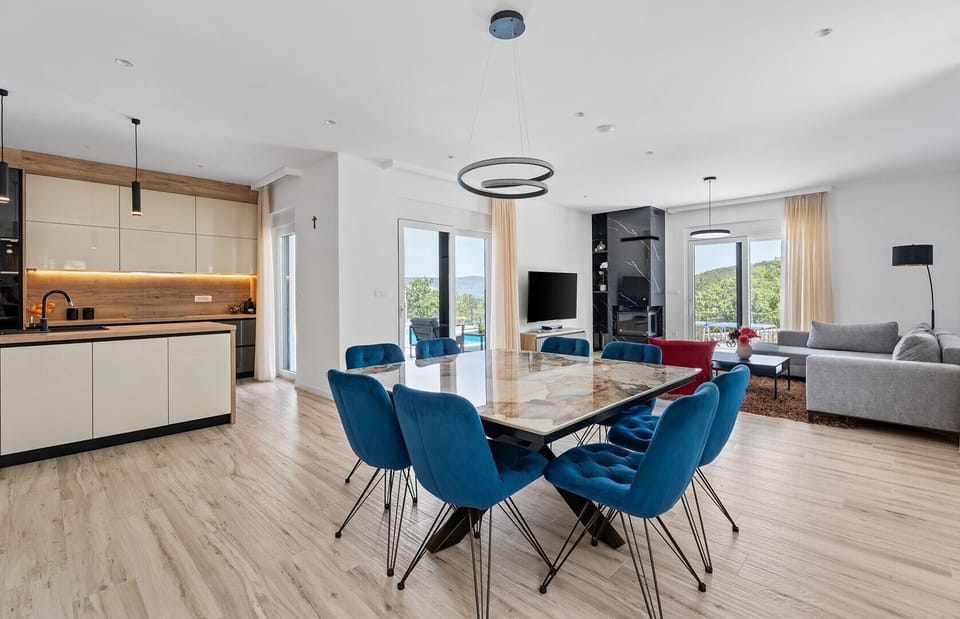 Comfortable dining area with an exit to the pool area