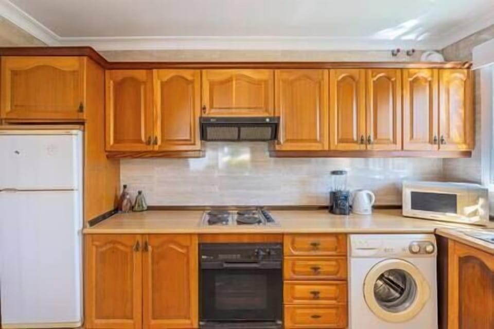 Bright, fully equipped American-style kitchen, perfect for a wonderful stay and includes a washer. (3)