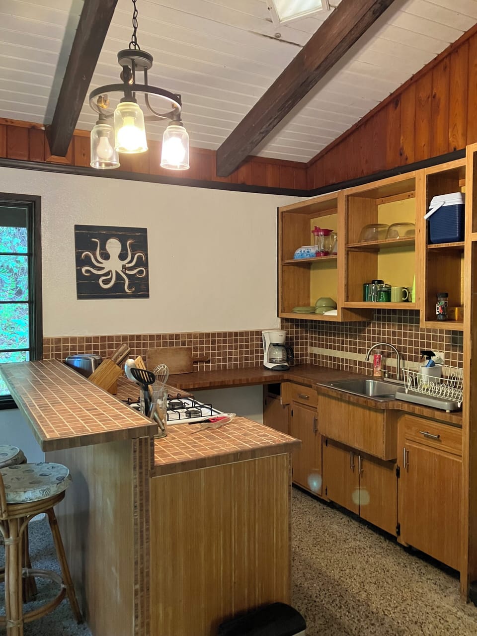 Kitchen/dining area plus island with bar stools for extra seating.
