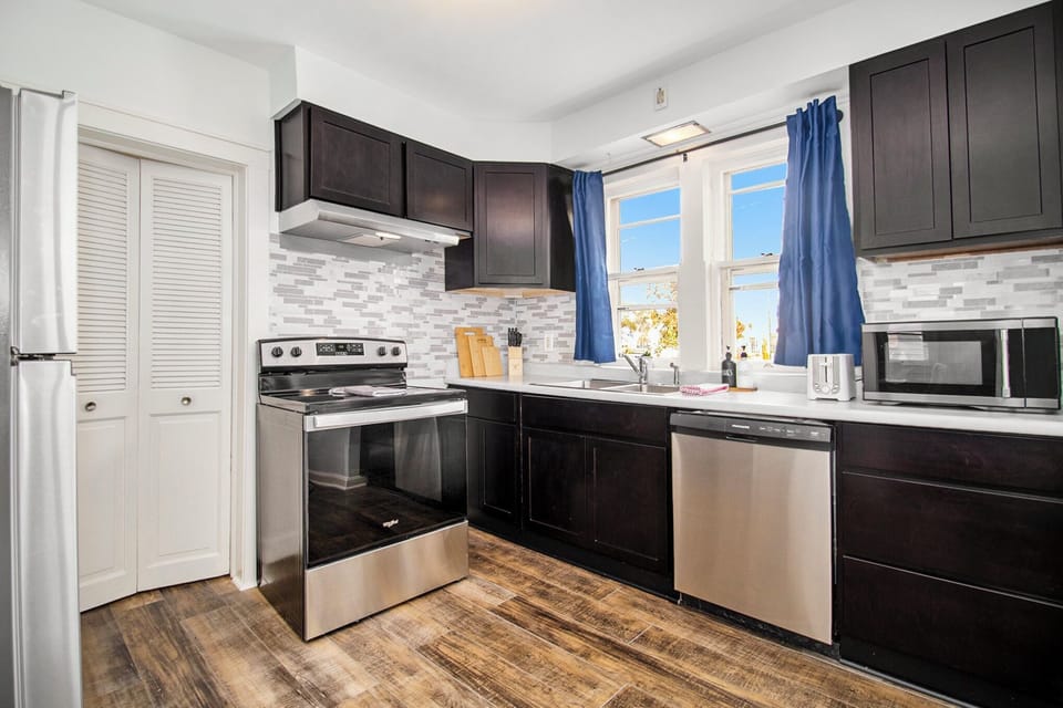 The kitchen is fully equipped with hardwood floors and modern appliances.