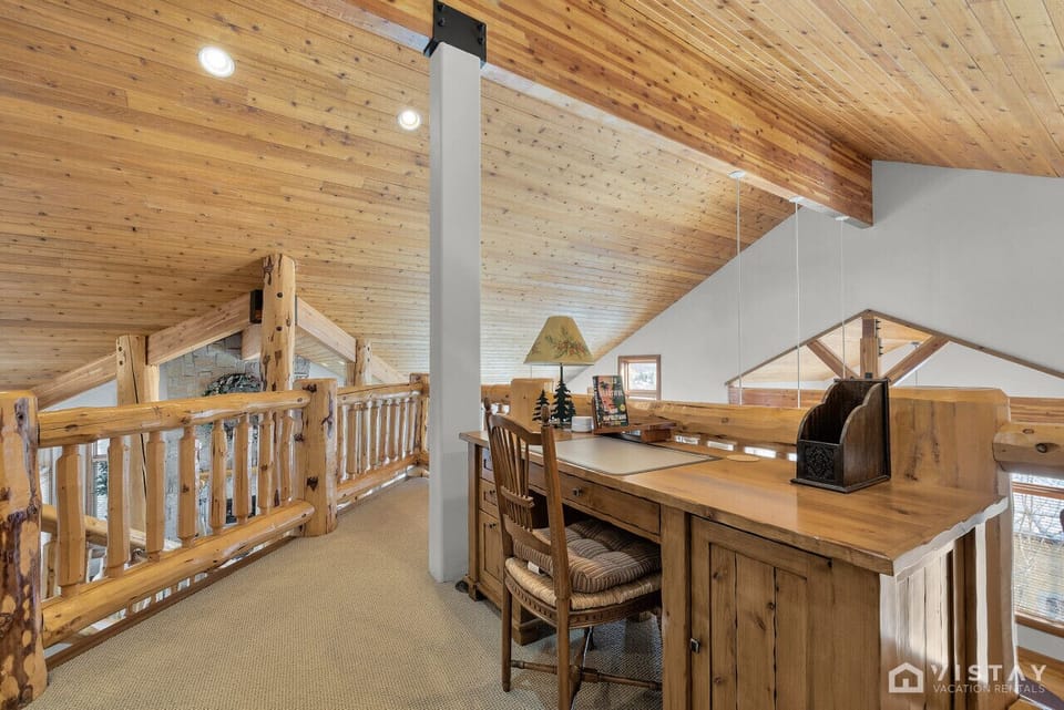 The loft features a dedicated workspace with a desk and chair