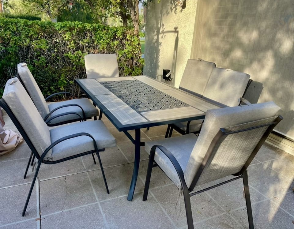 Brand new chairs and table on other side of outdoor patio