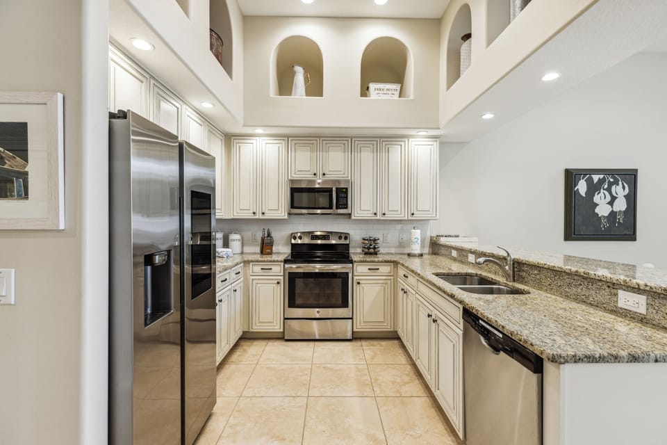 Enjoy a fully equipped kitchen with a sleek double-door fridge, perfect for cooking and entertaining.