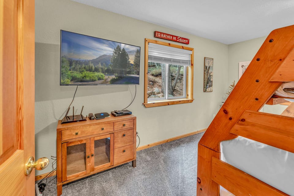 Bedroom 3: Bunk room with twin-over-full bunk bed, dresser, 50” Smart TV, ground floor
