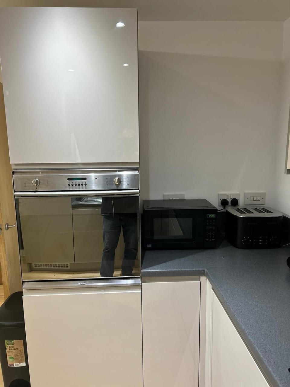 Compact kitchen area featuring a small oven, microwave and a toaster, perfect for preparing quick meals and snacks