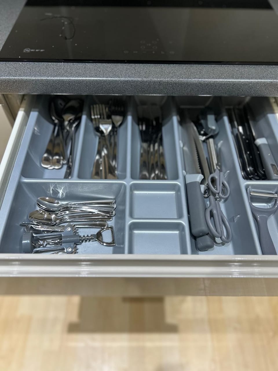 Well-stocked cabinet with utensils, perfect for all your dining and cooking needs during your stay