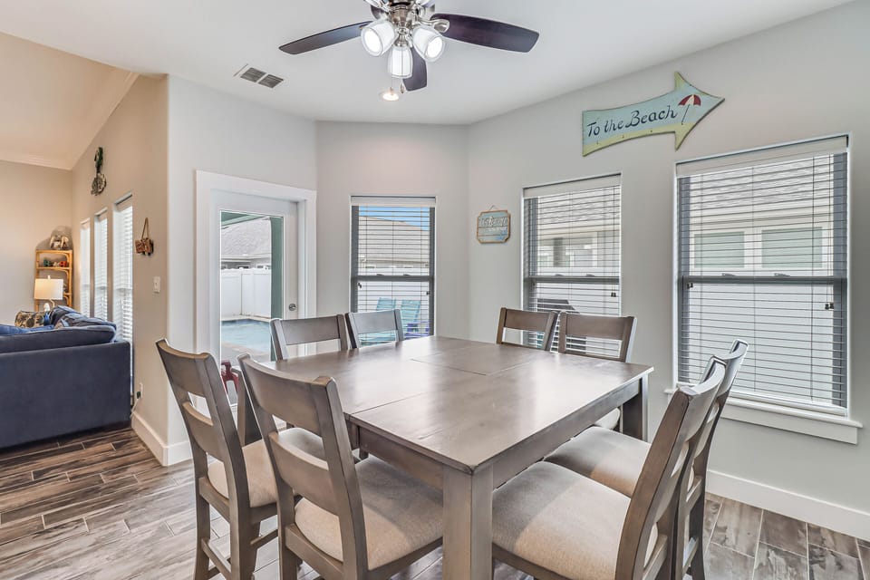 Gather around your spacious dining table where beach-themed decor sets the mood for memorable meals together.