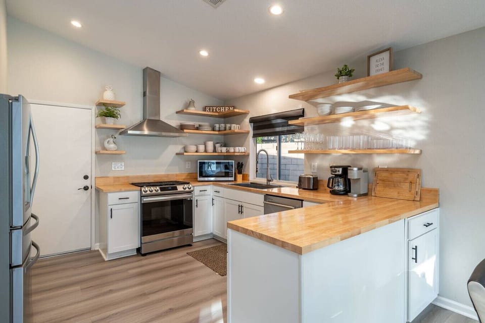 Open concept kitchen: living space, smart tv, 8-person dining table, 8-foot biliards