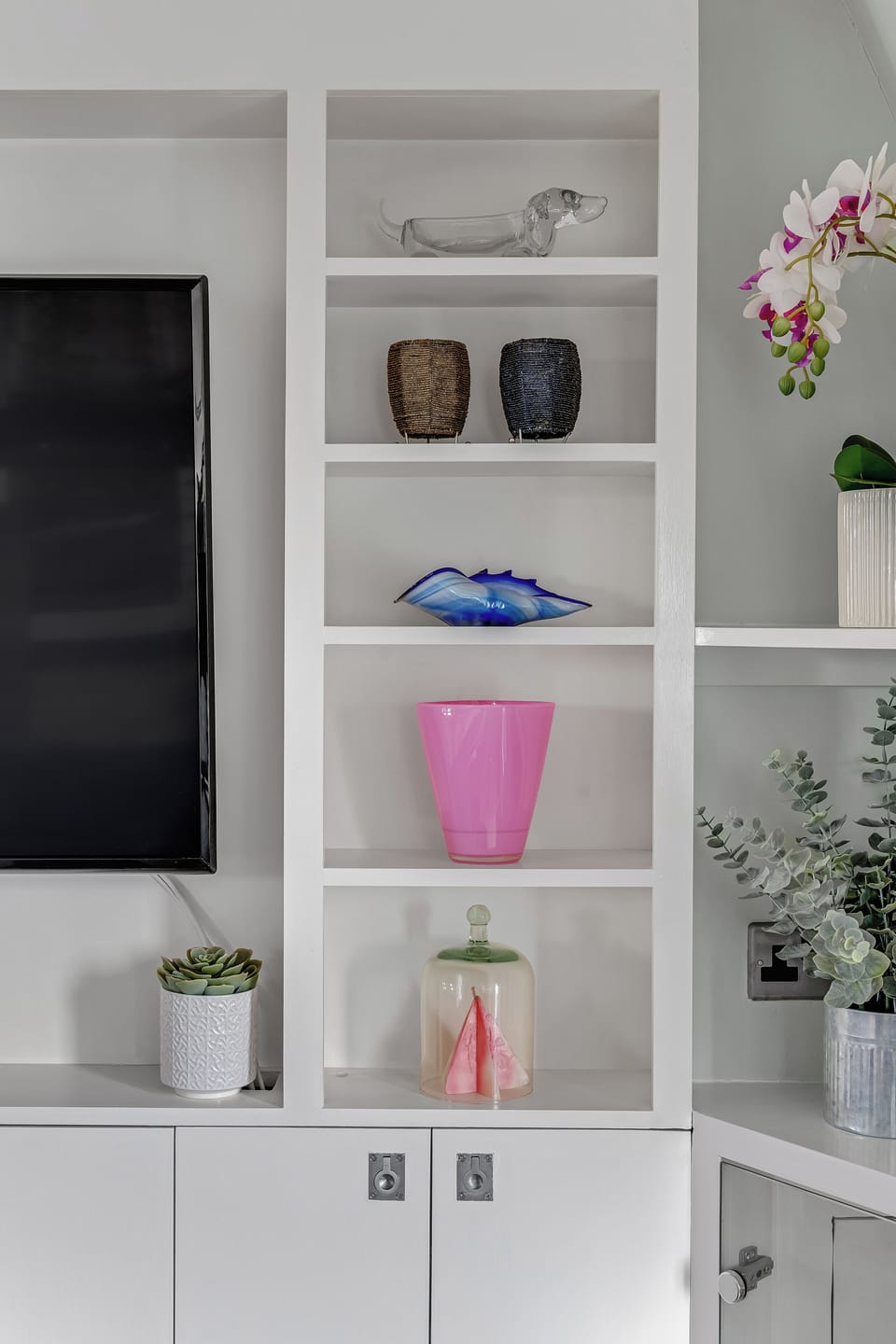 Hand blown glass object fill the shelves 