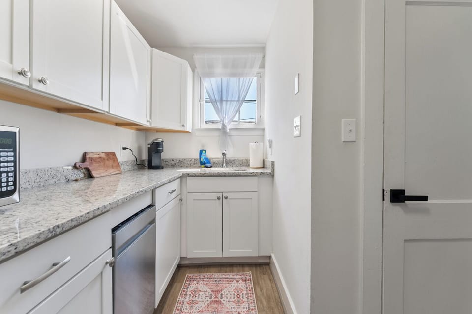 Fully equipped kitchen with stainless steel appliances and ample storage.