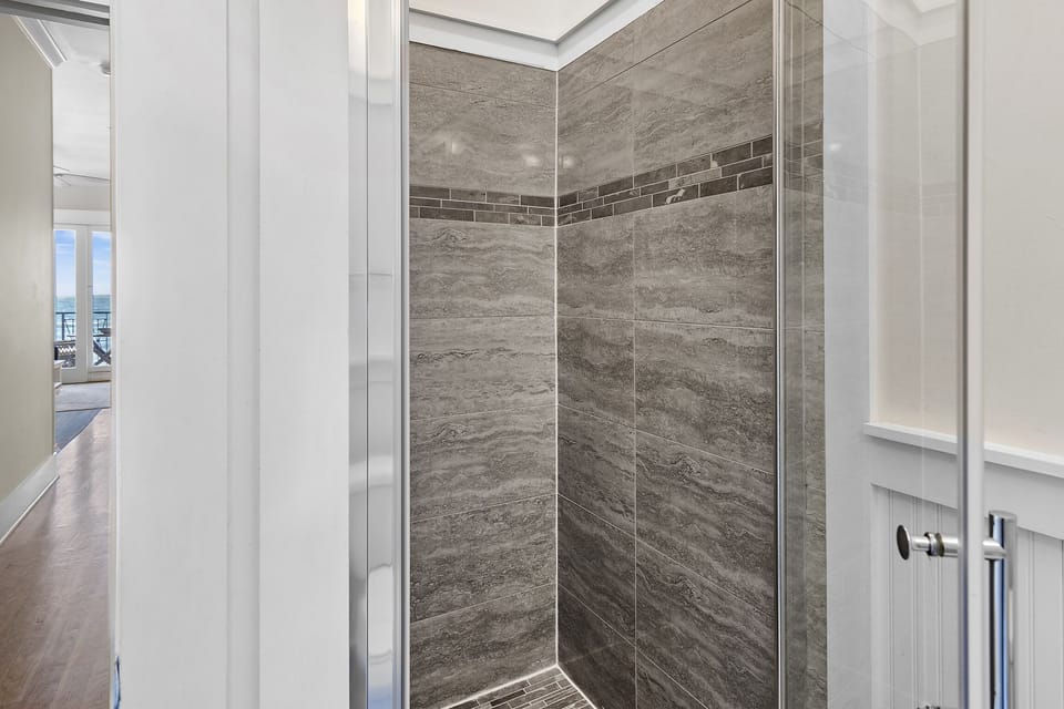 Spacious Master Bedroom (3rd Floor) with King Bed, 55" Smart TV, Gulf Views, Private Balcony, Bathroom with dual vanity, soaker tub & walk-in shower