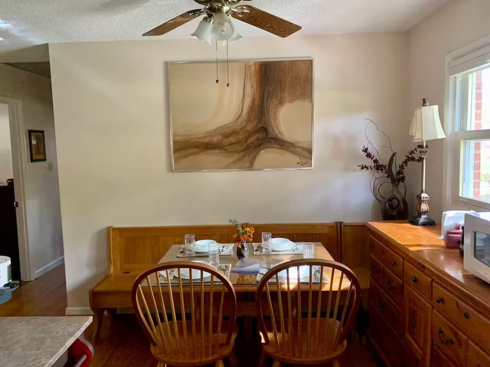 The dining room has dishware, a microwave, tea kettle and coffee maker.