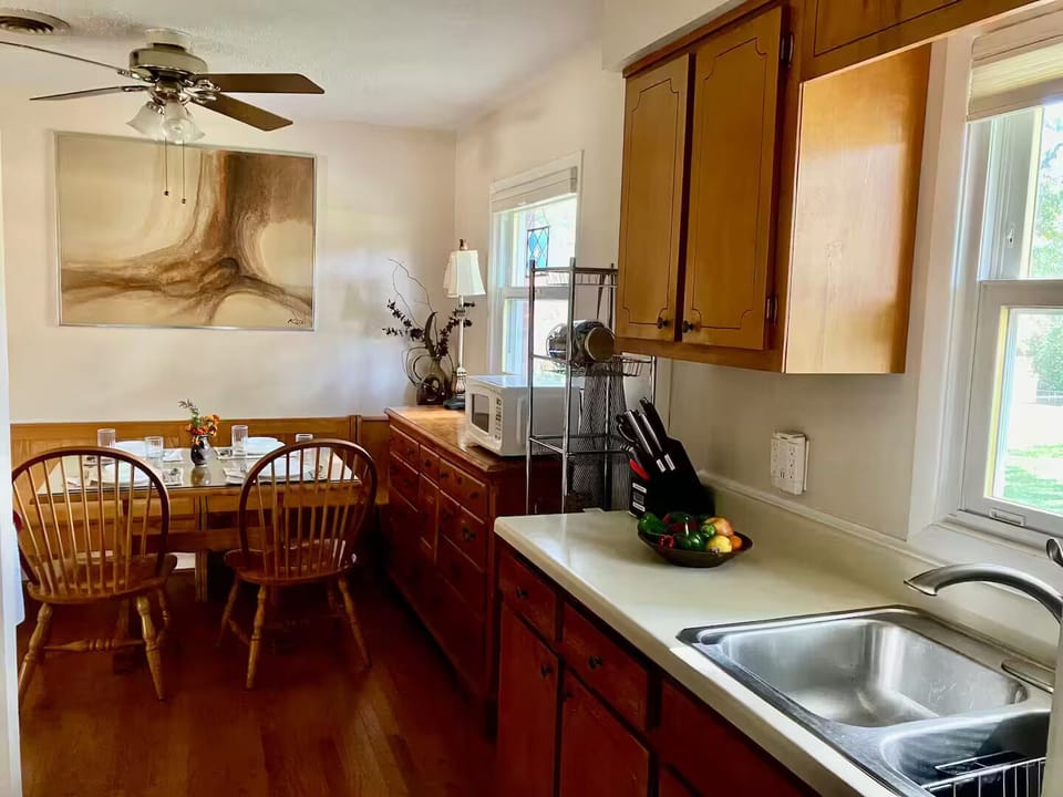 The kitchen and dining area are well-stocked for preparing and serving a meal.