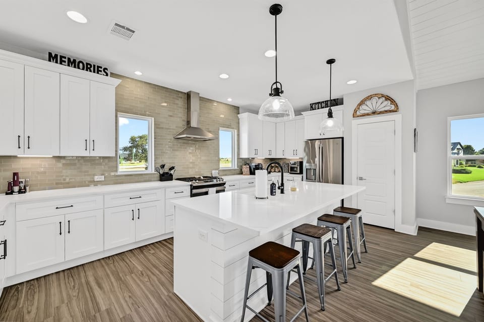 Kitchen with large counter and stools