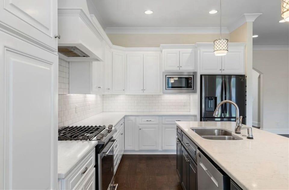 Full kitchen with necessary utensils and pans