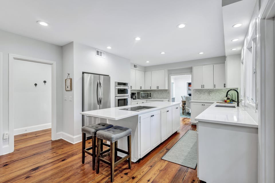 Top-tier stainless appliances featuring professional double oven and large fridge