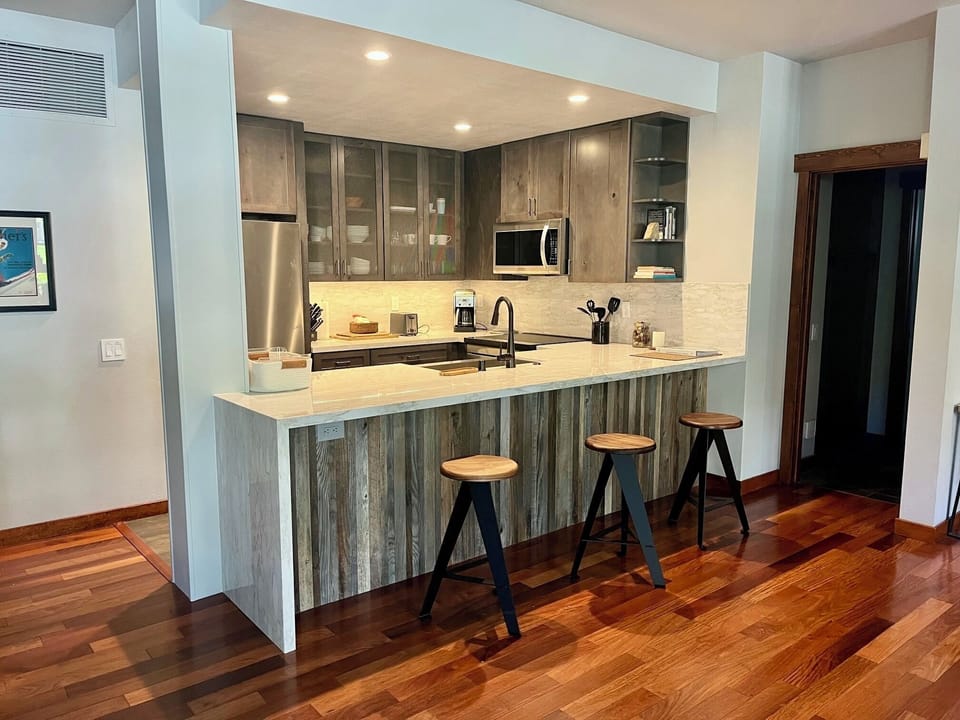Remodeled kitchen with new cabinets, countertops, and new stainless steel appliances.