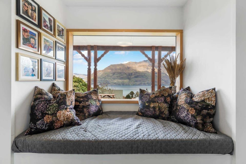 Reading Nook: Enjoy breathtaking views from this charming alcove with plush pillows and decor.