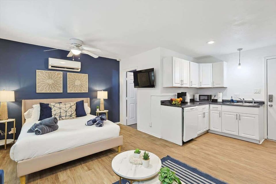 Unwind in this beautifully designed primary suite, featuring a plush queen bed, modern decor, and a convenient kitchenette