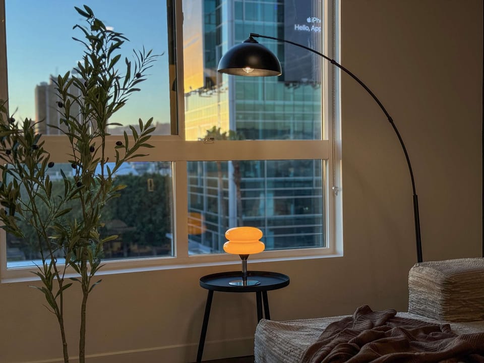 Sunbathed Hollywood Style Apartment Living room with a sofa, and a 55" Smart TV (Netflix, Hulu, and Disney+ we logged them remotely) included for free.