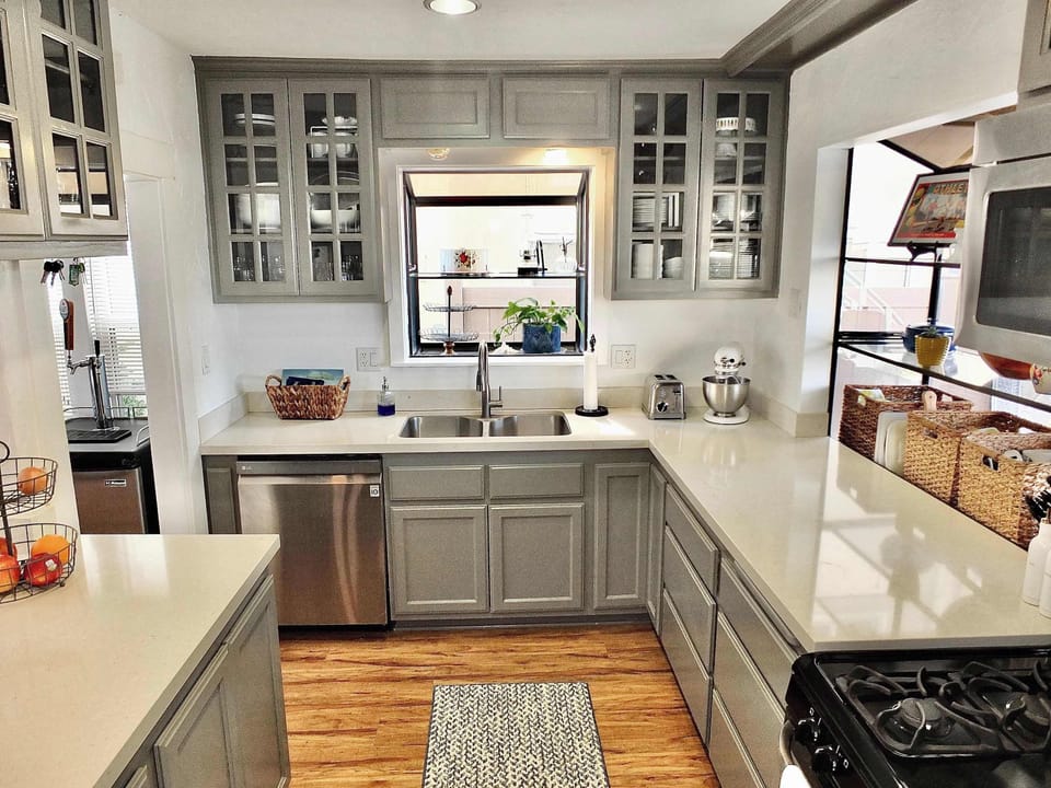 The airy kitchen offers ample space & all the comforts of home