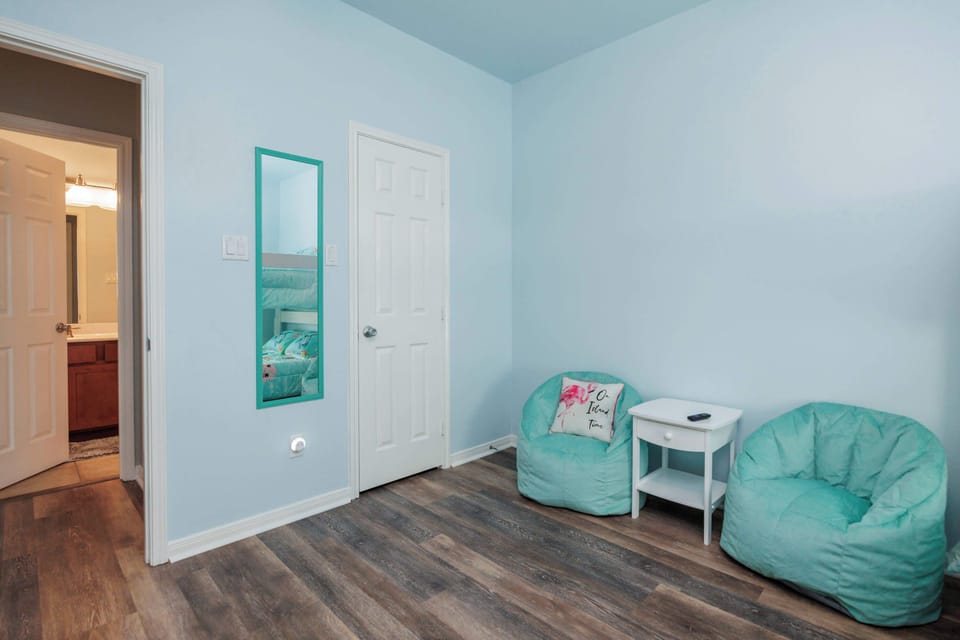 Bedroom 3 with queen/queen bunk bed, children's sitting area, and TV