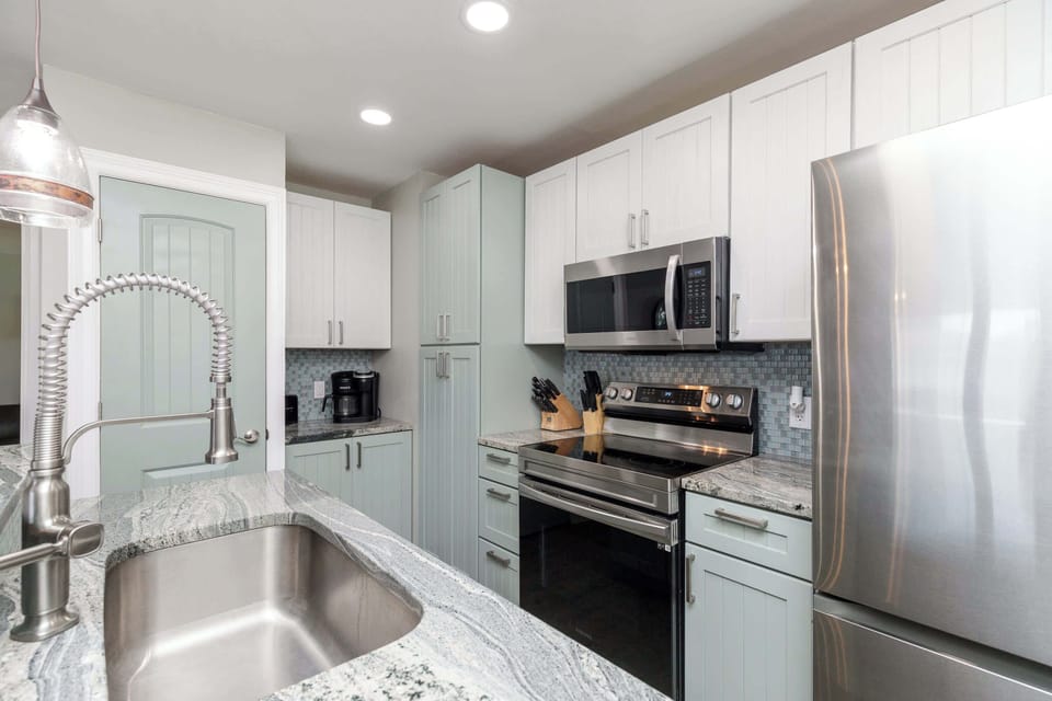 The updated, beachy kitchen offers ample space & all the comforts of home