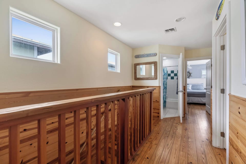 Upstairs hallway with view of full bath king bedroom