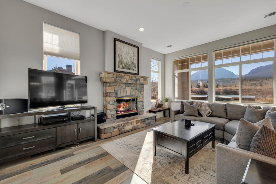 Cozy Living Room with Fireplace, TV, and tons of natural light