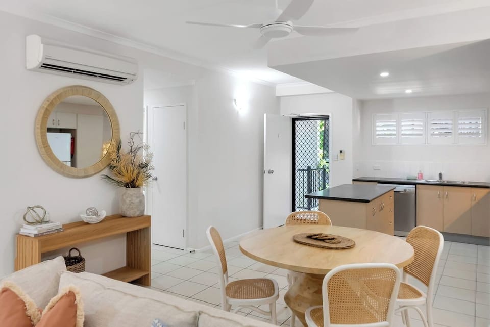 The open-plan lounge and dining area provides a comfortable space to gather, with soft seating, air conditioning, and direct access to the patio.
