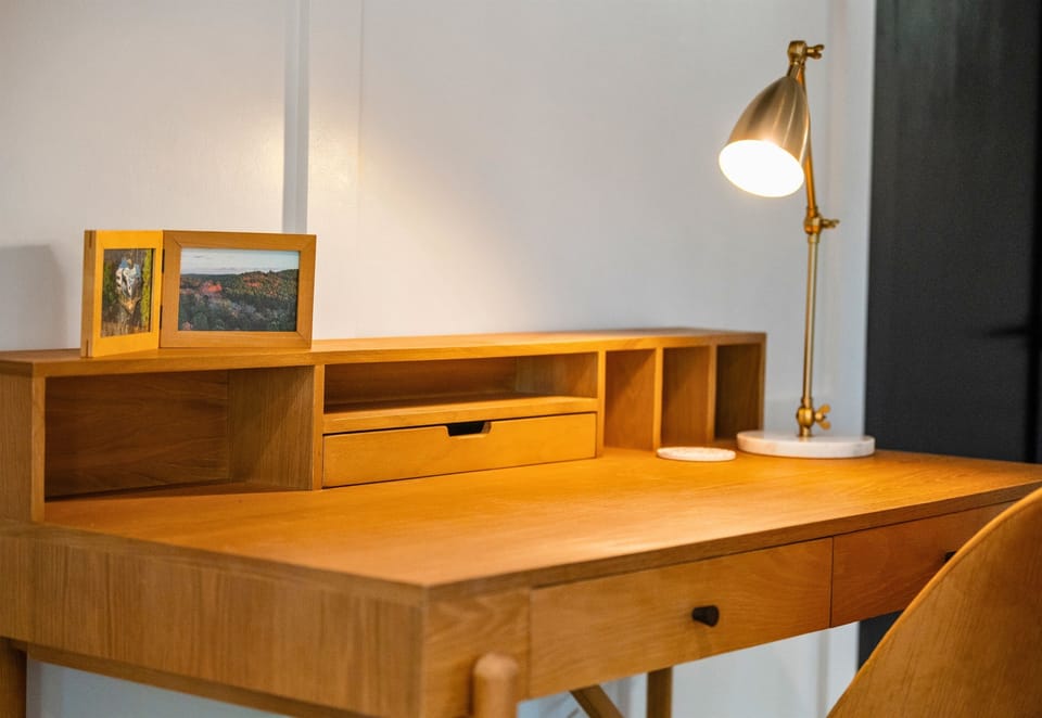 A cozy workspace with warm wood tones, perfect for catching up on reading or journaling about your adventures in the mountains.
