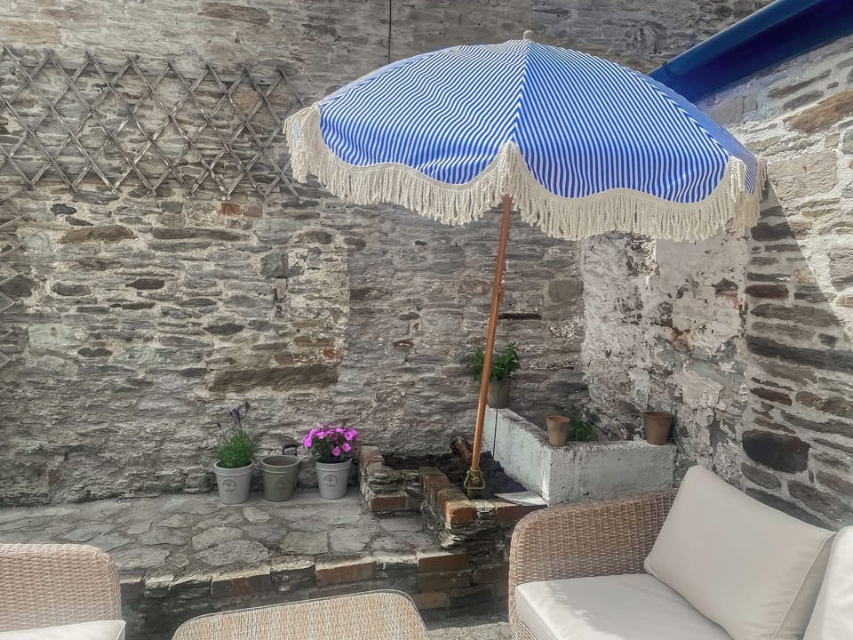 Striped blue and white summer umbrella and vegetable and herb patch | | Le Grand Bleu, Bantham Beach