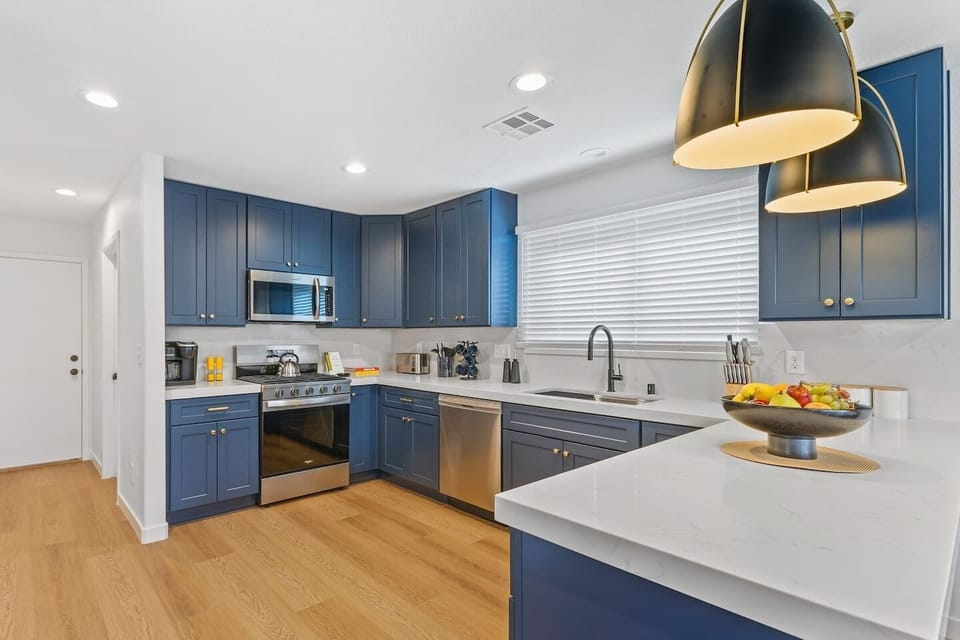 Our brand new designer kitchen includes a white quartz countertop and all the conveniences of a modern kitchen. - Adventure Awaits