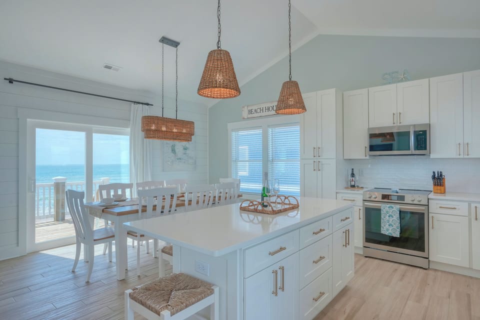 Kitchen and Dining areas. Seating for 12. Slider doors to top deck.
