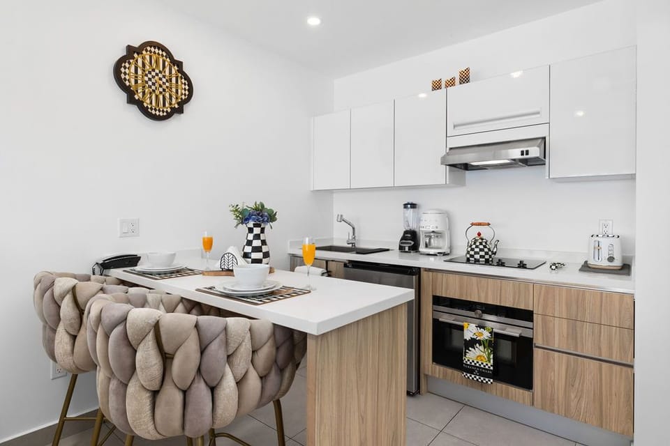 In-unit washer and dryer tucked neatly into your hallway closet, with stunning ocean views awaiting you just steps away in the bright, tiled living space.
